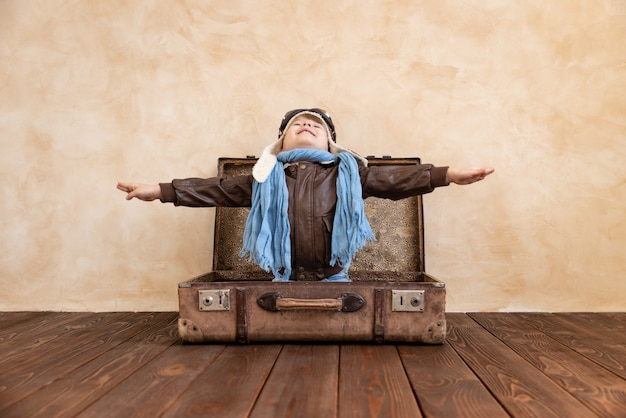 Happy child wearing vintage aviator costume.