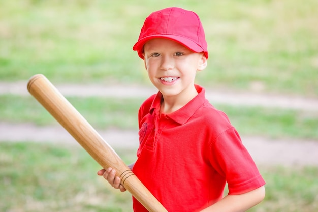 A Happy child with baseball bat on nature concept in park