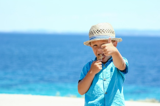 A happy child with ice cream by the sea on weekend travel shore