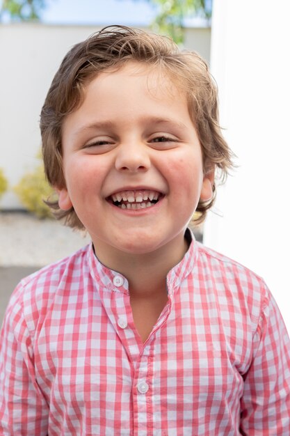 Happy child with pink shirt in the garden 