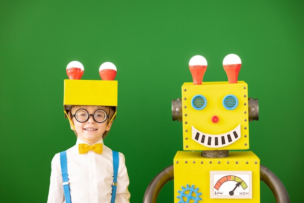 Happy child with toy robot in class