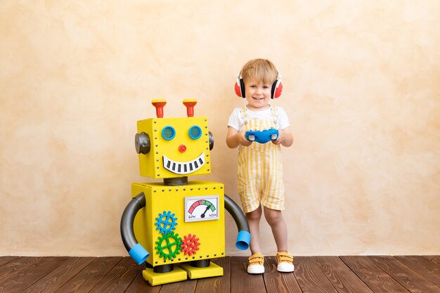 Happy child with toy robot