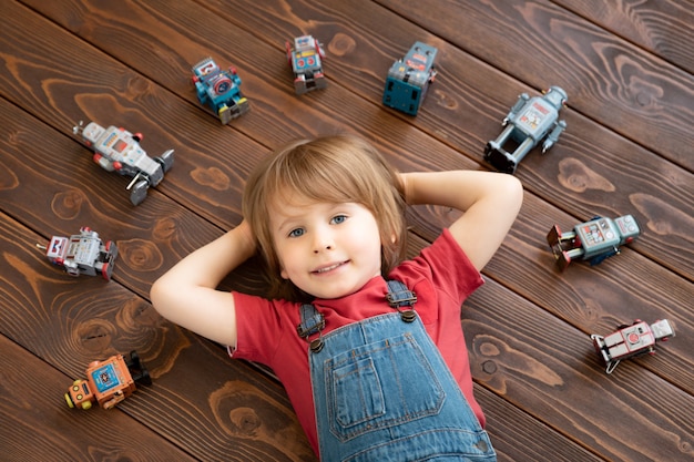 Happy child with toy robot.