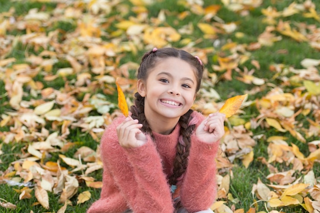 Happy childhood School time Happy little girl in autumn forest Autumn leaves and nature Small child with autumn leaves I would stay here forever No rush Real relaxation Feeling comfortable