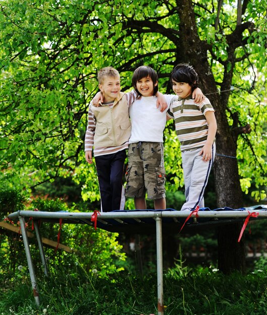 Happy children enjoying childhood on trampoline