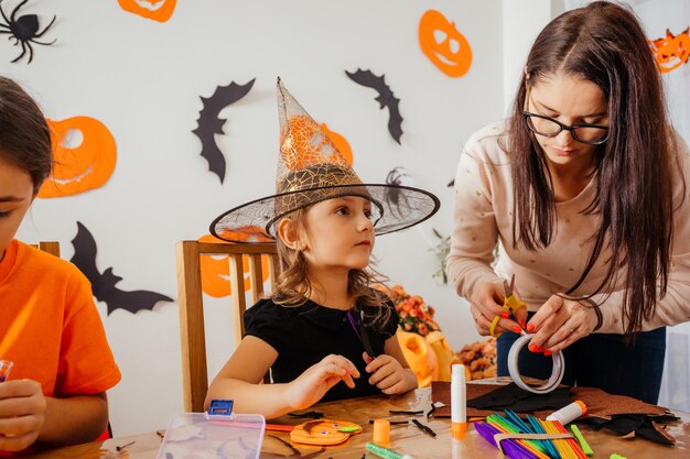 Happy children during Halloween art lesson at home