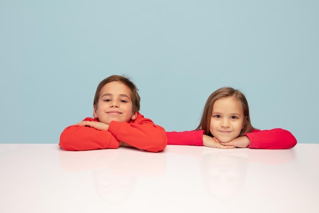 Happy children isolated on blue studio background look happy\
cheerful sincere copyspace childhood education emotions\
concept