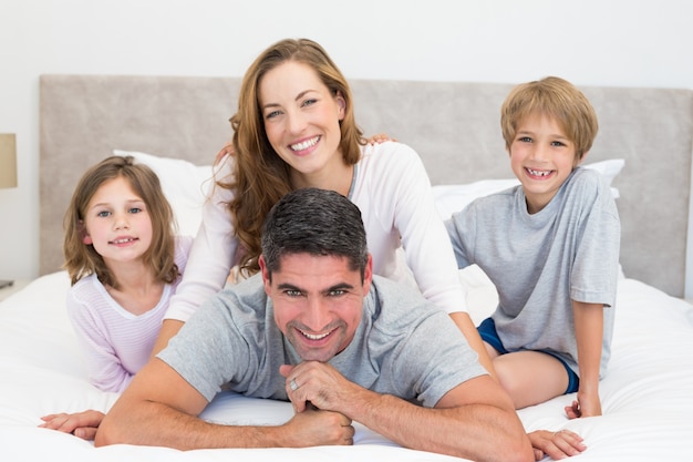 Happy children and parents in bed