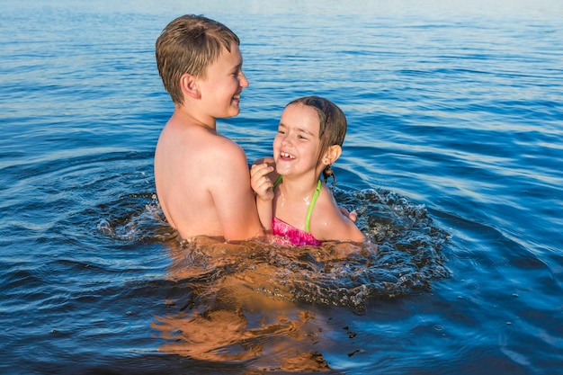 Happy children play in the water summer vacation active lifestyle