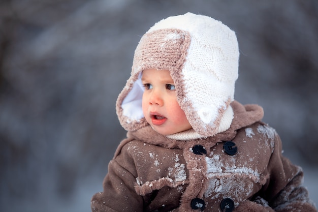 Happy children playing in the snow in winter