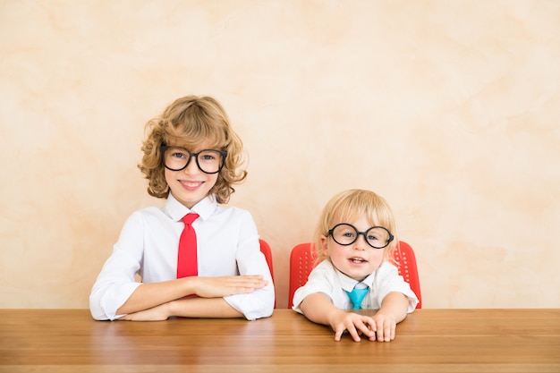 Happy children pretend to be businessmen