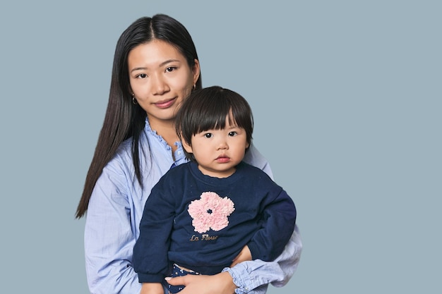 Happy Chinese mother hugging her child