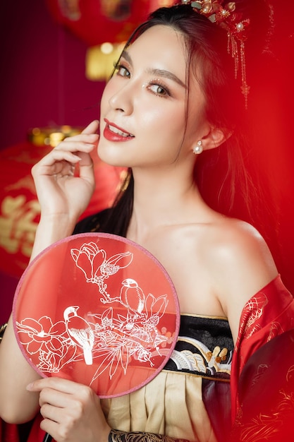 Happy Chinese new year Beautiful Asian woman wearing traditional cheongsam qipao dress