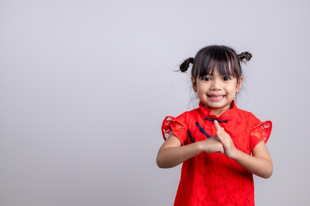 Happy Chinese new year. Little Asian girls with Congratulation gesture