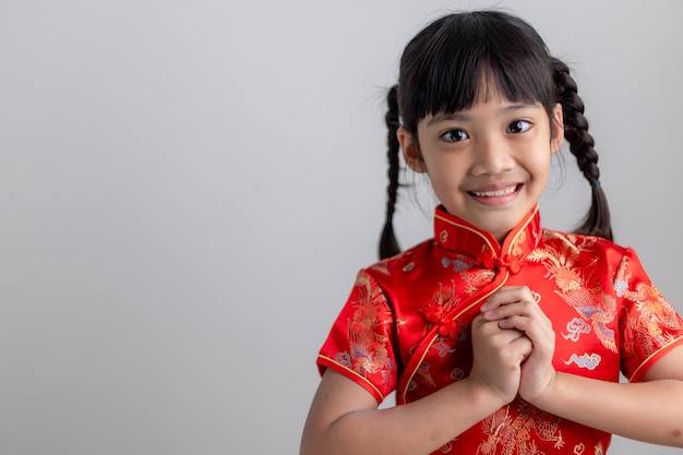 Happy Chinese new year. Little Asian girls with Congratulation gesture