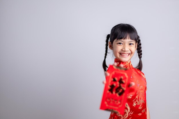 Happy Chinese new year. smiling Asian little girls holding red envelope