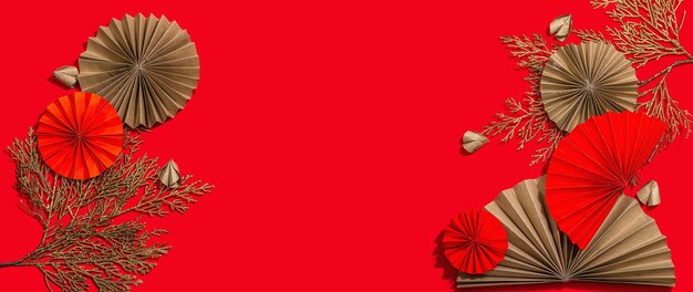 Happy Chinese New Year traditional concept Oriental asian style paper fans on red background minimal concept flat lay banner format