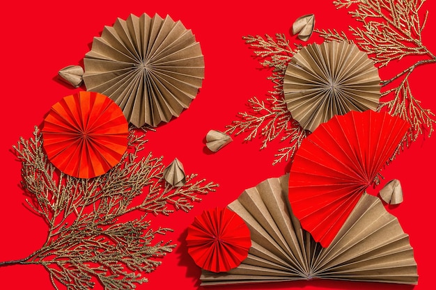 Happy Chinese New Year traditional concept Oriental asian style paper fans on red background minimal concept flat lay top view