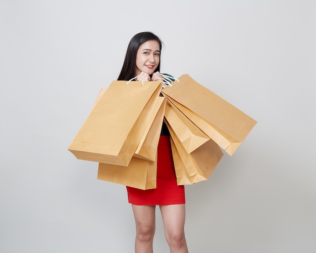 Happy Christmas Asian woman shopping holding paper bags