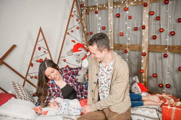 Happy Christmas family. Happy family at christmas time. Parents and baby.