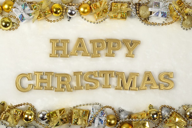 Happy christmas golden text and Christmas decorations on a white background