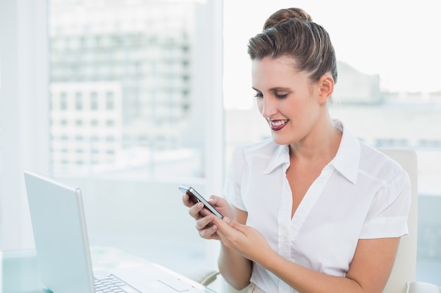 Happy classy businesswoman using phone 