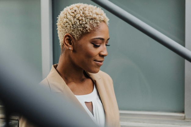 Happy confident black businesswoman by the steps