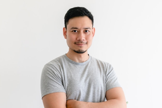 Happy and confident man in grey t-shirt on isolated