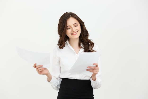 Happy confident young caucasian woman holding report paper standing smiling isolated