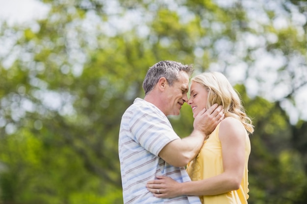 Happy couple about to kiss outside