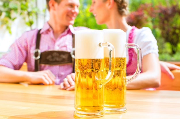 Happy Couple in Beer garden drinking beer