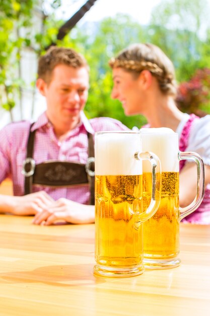 Happy Couple in Beer garden drinking beer