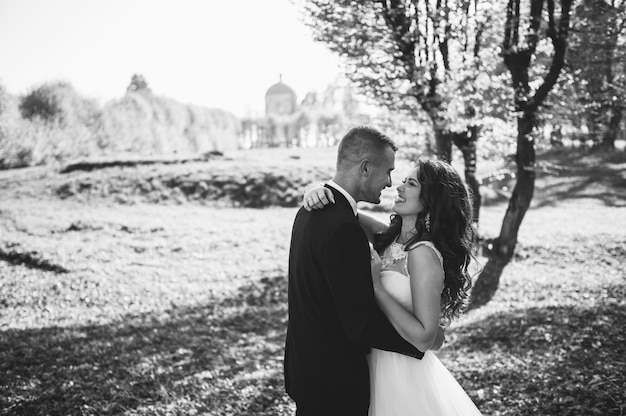 Happy couple of brides walking in autumn park