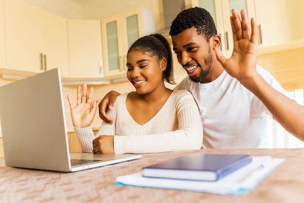 Happy couple calling by video chat to family from their new apartment