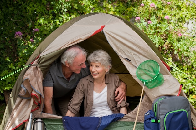 Happy couple camping in the garden