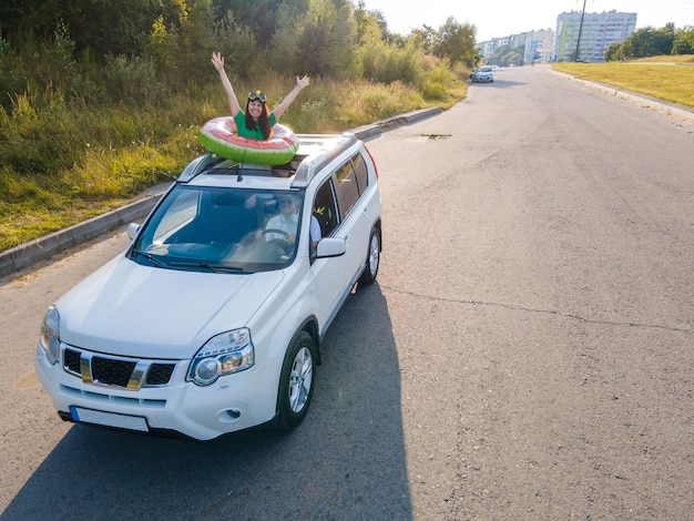 Happy couple in car overhead view car travel to sea concept