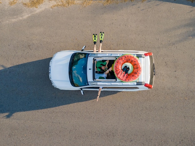 Happy couple in car overhead view car travel to sea concept