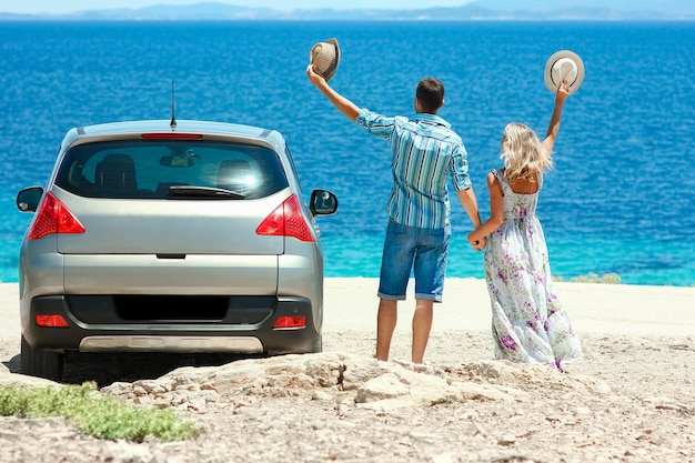 A happy couple cars by the sea in nature weekend travel