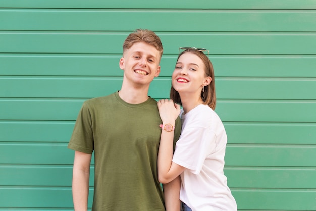 Happy couple in casual clothing stands