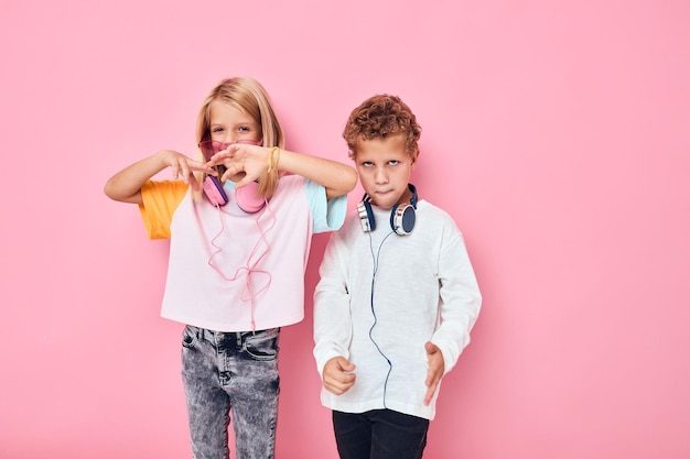 Happy couple child wearing headphones posing listening music