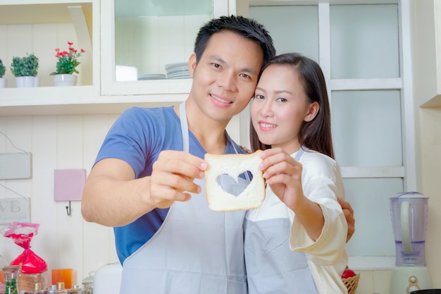 happy couple cooking together in the kitchen