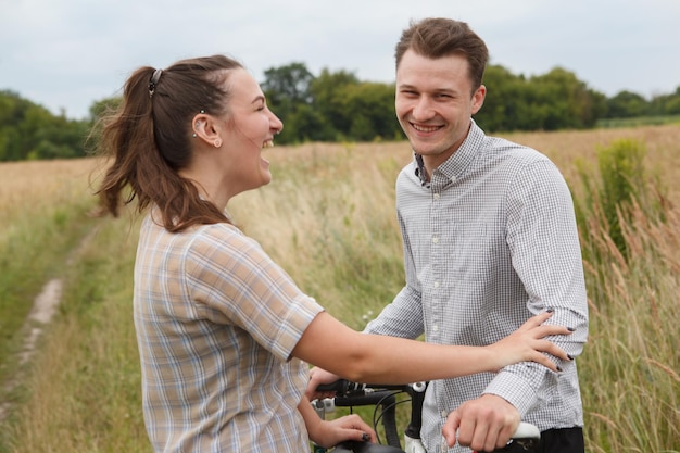 Photo the happy couple cycling near the field