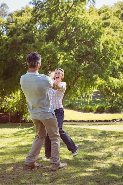 Happy couple dancing in the park