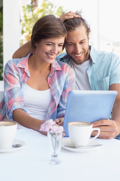 Happy couple on a date using tablet pc