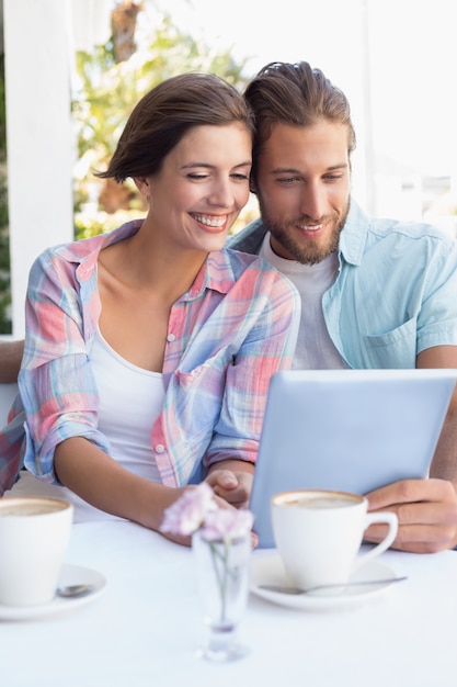 Happy couple on a date using tablet pc