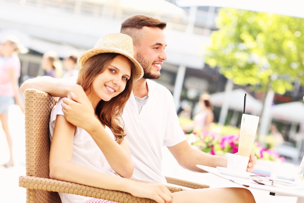 a happy couple drinking coffee in a cafe