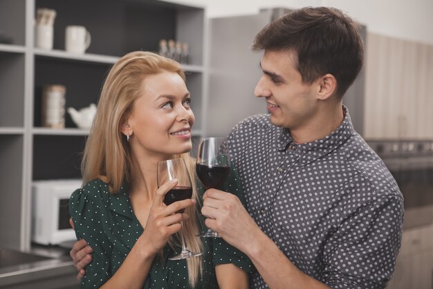 Happy couple drinking wine together at home