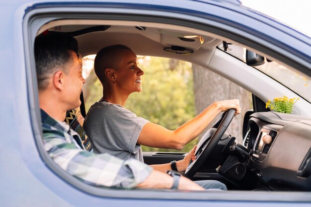 Happy couple driving camper van during road trip