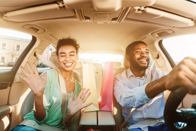 Photo happy couple driving home after shopping in mall