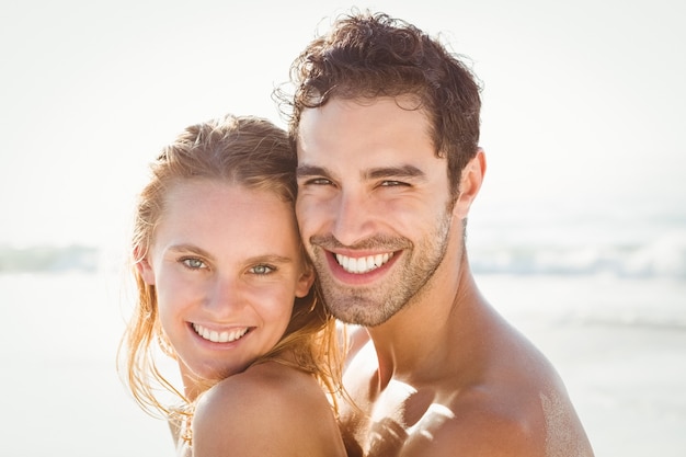 Happy couple embracing on the beach